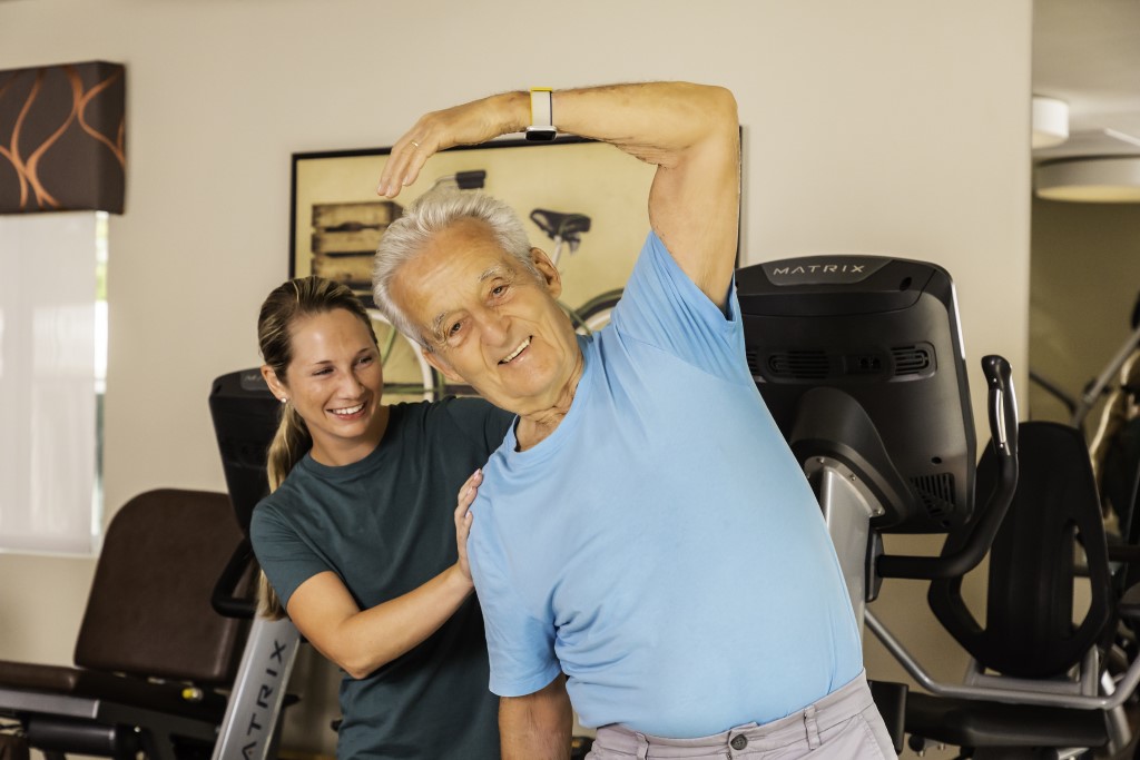 Woman helping a man stretch